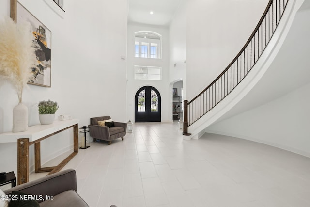 465 Deer Valley Dr, Ponte Vedra, FL 32081 - entrance foyer featuring arched walkways, stairs, a high ceiling, french doors, and baseboards