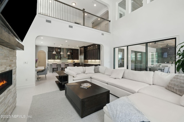 465 Deer Valley Dr, Ponte Vedra, FL 32081 - living room with arched walkways, a fireplace, and a high ceiling