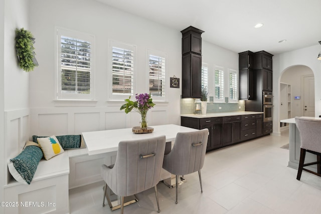 465 Deer Valley Dr, Ponte Vedra, FL 32081 - dining room with arched walkways, a decorative wall, recessed lighting, and a wainscoted wall