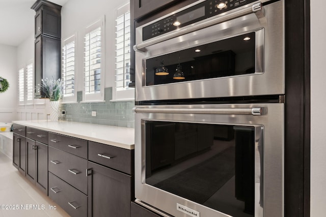 465 Deer Valley Dr, Ponte Vedra, FL 32081 - kitchen featuring stainless steel double oven, light countertops, tasteful backsplash, and dark brown cabinetry