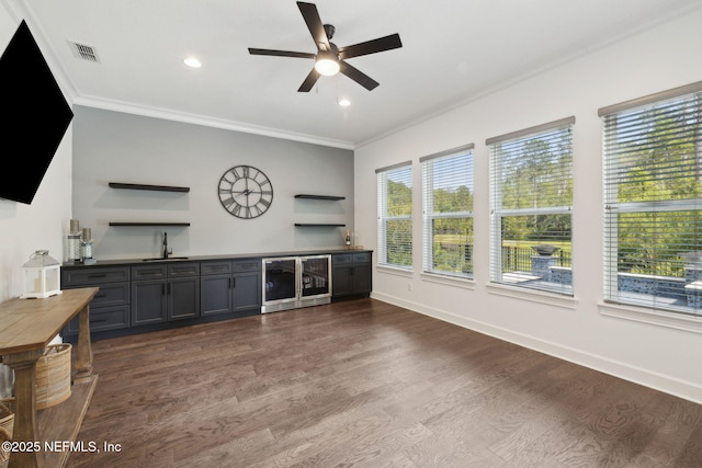 465 Deer Valley Dr, Ponte Vedra, FL 32081 - unfurnished living room featuring dark wood-style flooring, ornamental molding, a ceiling fan, beverage cooler, and bar