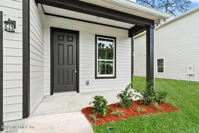 171 Cougar Rd, Jacksonville, FL 32220 - view of exterior entry featuring covered porch and a yard