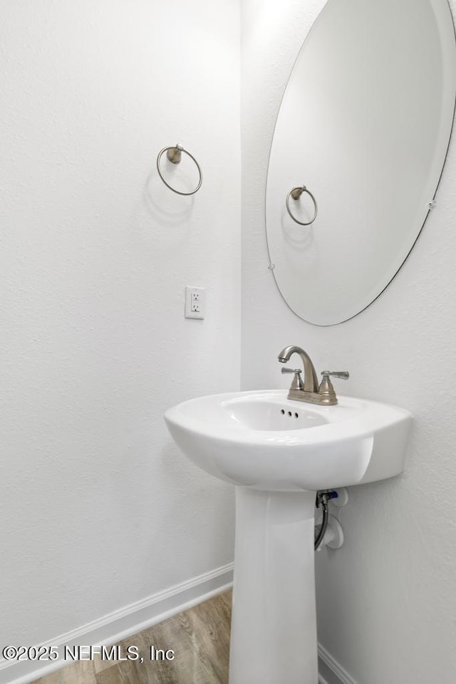 171 Cougar Rd, Jacksonville, FL 32220 - bathroom featuring baseboards, wood finished floors, and a sink