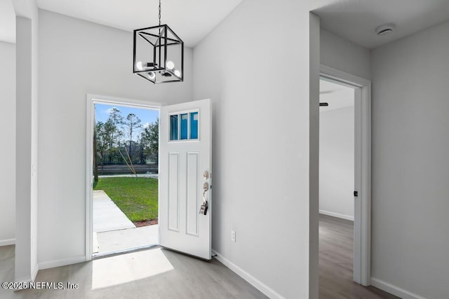7830 Smart Ave, Jacksonville, FL 32219 - entrance foyer with a chandelier, wood finished floors, and baseboards