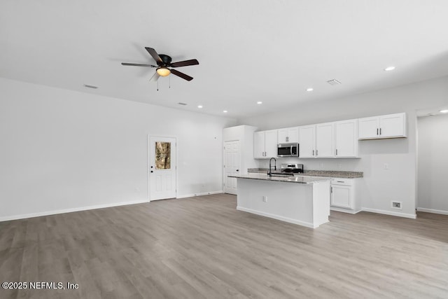 7830 Smart Ave, Jacksonville, FL 32219 - kitchen featuring stainless steel appliances, open floor plan, white cabinetry, a ceiling fan, and recessed lighting