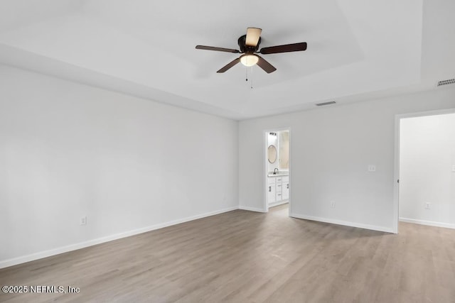 7830 Smart Ave, Jacksonville, FL 32219 - spare room with a ceiling fan, a raised ceiling, light wood-style floors, baseboards, and a sink