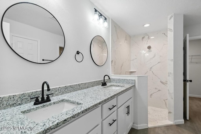 7830 Smart Ave, Jacksonville, FL 32219 - full bathroom with a marble finish shower, double vanity, recessed lighting, wood finished floors, and baseboards