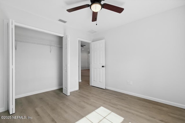 7830 Smart Ave, Jacksonville, FL 32219 - unfurnished bedroom featuring wood finished floors, a closet, baseboards, and ceiling fan