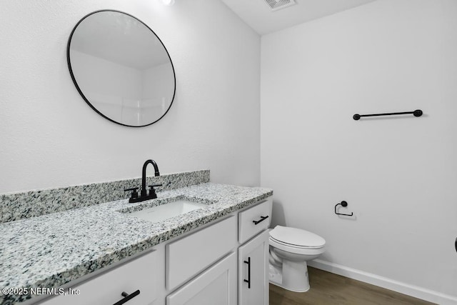7830 Smart Ave, Jacksonville, FL 32219 - bathroom with wood finished floors, vanity, toilet, and baseboards