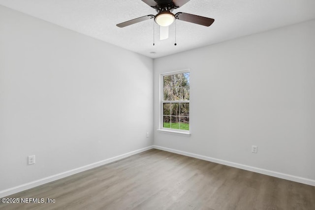 7830 Smart Ave, Jacksonville, FL 32219 - unfurnished room featuring wood finished floors, baseboards, a ceiling fan, and a textured ceiling