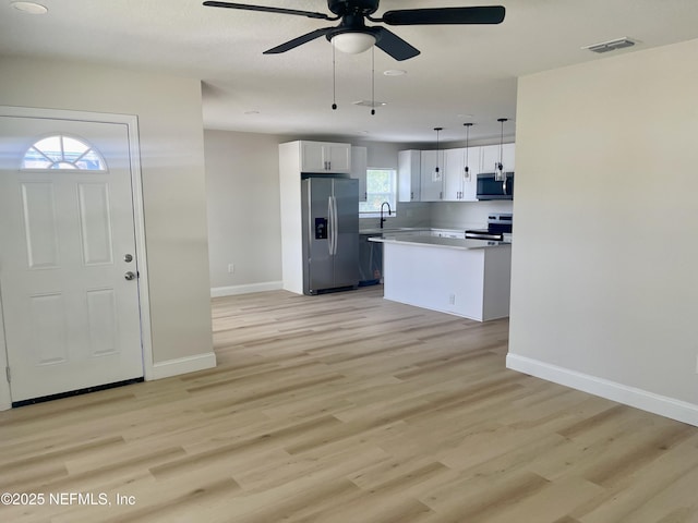 1046 Line St, Jacksonville, FL 32209 - kitchen with stainless steel appliances, a ceiling fan, white cabinetry, and baseboards