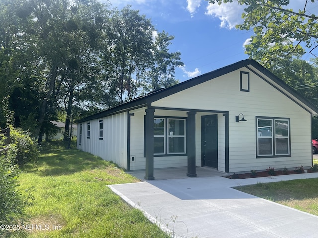 1046 Line St, Jacksonville, FL 32209 - view of front of home featuring covered porch, a front lawn, and board and batten siding