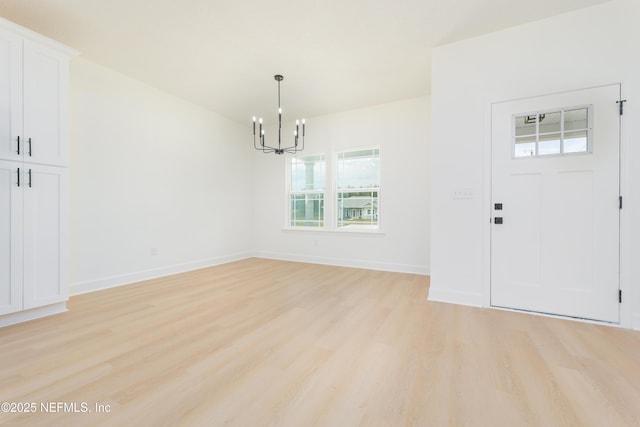 6249 Blue Marlin Dr, Keystone Heights, FL 32656 - foyer entrance with a chandelier, light wood finished floors, and baseboards