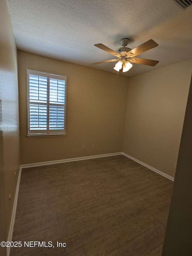 12301 Kernan Forest Blvd Unit 508, Jacksonville, FL 32225 - unfurnished room with a ceiling fan, a textured ceiling, baseboards, and dark wood-style floors