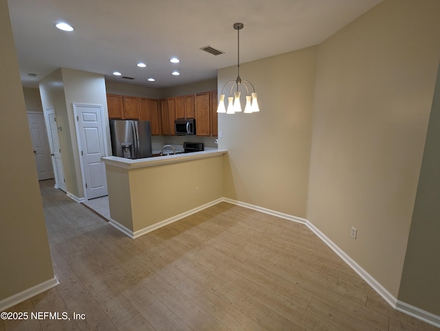 12301 Kernan Forest Blvd Unit 508, Jacksonville, FL 32225 - kitchen with stainless steel appliances, a peninsula, a chandelier, baseboards, and recessed lighting