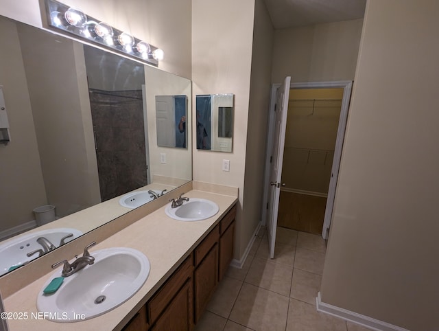 12301 Kernan Forest Blvd Unit 508, Jacksonville, FL 32225 - full bathroom featuring tile patterned flooring, double vanity, baseboards, and a spacious closet