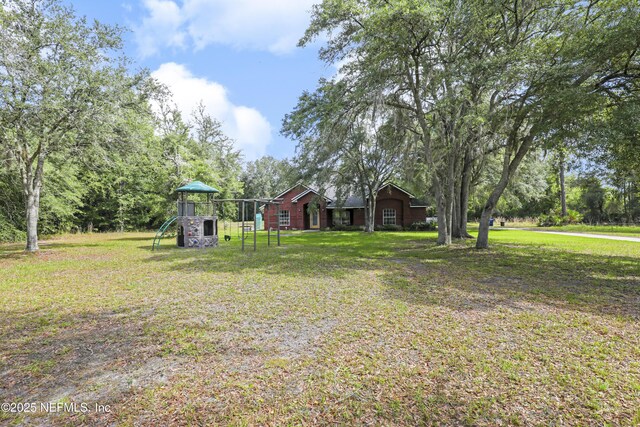 3784 Charles Green Rd, Hilliard, FL 32046 - view of green lawn with a playground