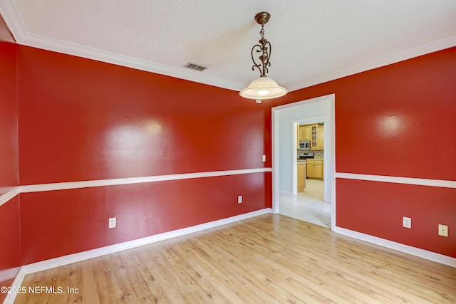3784 Charles Green Rd, Hilliard, FL 32046 - spare room featuring wood finished floors, ornamental molding, and baseboards