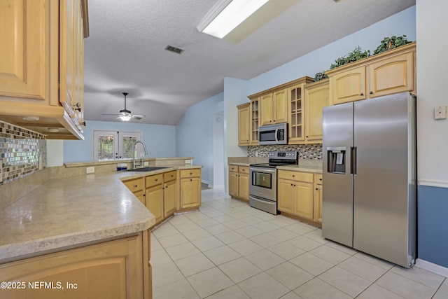 3784 Charles Green Rd, Hilliard, FL 32046 - kitchen with stainless steel appliances, a sink, backsplash, light countertops, and a peninsula