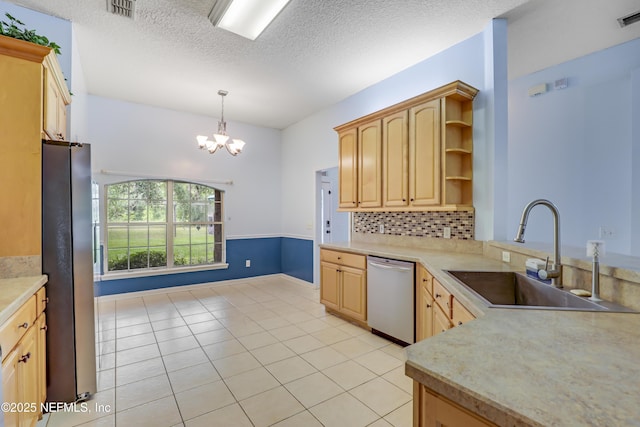3784 Charles Green Rd, Hilliard, FL 32046 - kitchen featuring stainless steel appliances, a sink, light brown cabinets, light countertops, and a textured ceiling