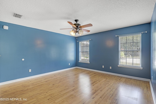 3784 Charles Green Rd, Hilliard, FL 32046 - spare room with plenty of natural light, a textured ceiling, ceiling fan, wood finished floors, and baseboards