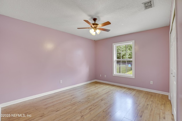 3784 Charles Green Rd, Hilliard, FL 32046 - empty room featuring baseboards, light wood-type flooring, a ceiling fan, and a textured ceiling