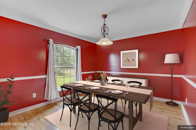 3784 Charles Green Rd, Hilliard, FL 32046 - dining area with light wood finished floors, a textured ceiling, ornamental molding, and baseboards