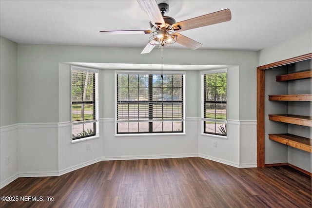 1344 Degrove Rd, Saint Johns, FL 32259 - unfurnished dining area with a wainscoted wall, wood finished floors, a ceiling fan, and baseboards