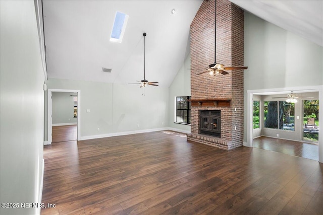 1344 Degrove Rd, Saint Johns, FL 32259 - unfurnished living room featuring high vaulted ceiling, ceiling fan, hardwood / wood-style flooring, a brick fireplace, and a skylight