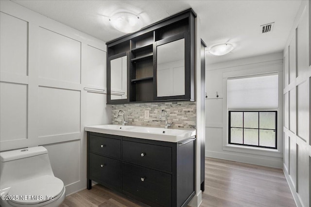 1344 Degrove Rd, Saint Johns, FL 32259 - full bathroom with wood finished floors, backsplash, double vanity, and toilet