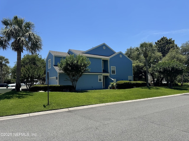 200 Spindrift Ln, Neptune Beach, FL 32266 - view of home's exterior featuring an attached garage and a lawn