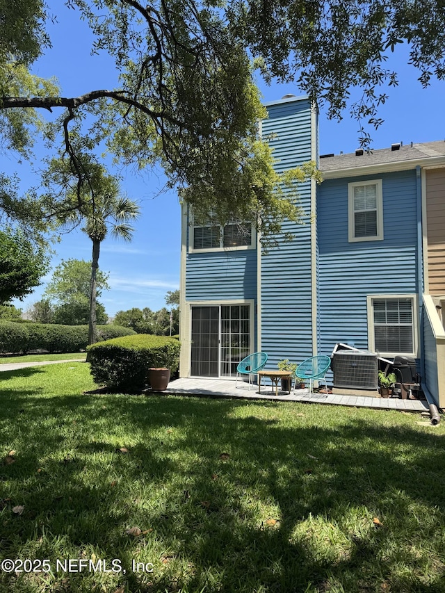 200 Spindrift Ln, Neptune Beach, FL 32266 - back of property featuring a yard, a patio area, and cooling unit