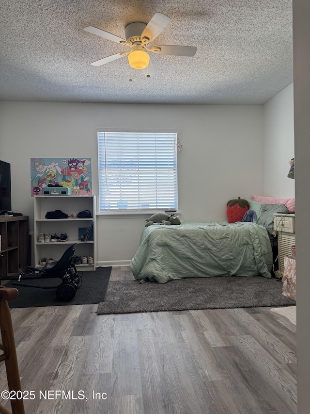 200 Spindrift Ln, Neptune Beach, FL 32266 - bedroom with wood finished floors, a textured ceiling, and a ceiling fan