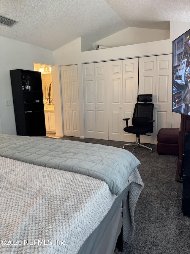 200 Spindrift Ln, Neptune Beach, FL 32266 - bedroom featuring carpet flooring, vaulted ceiling, two closets, and a textured ceiling