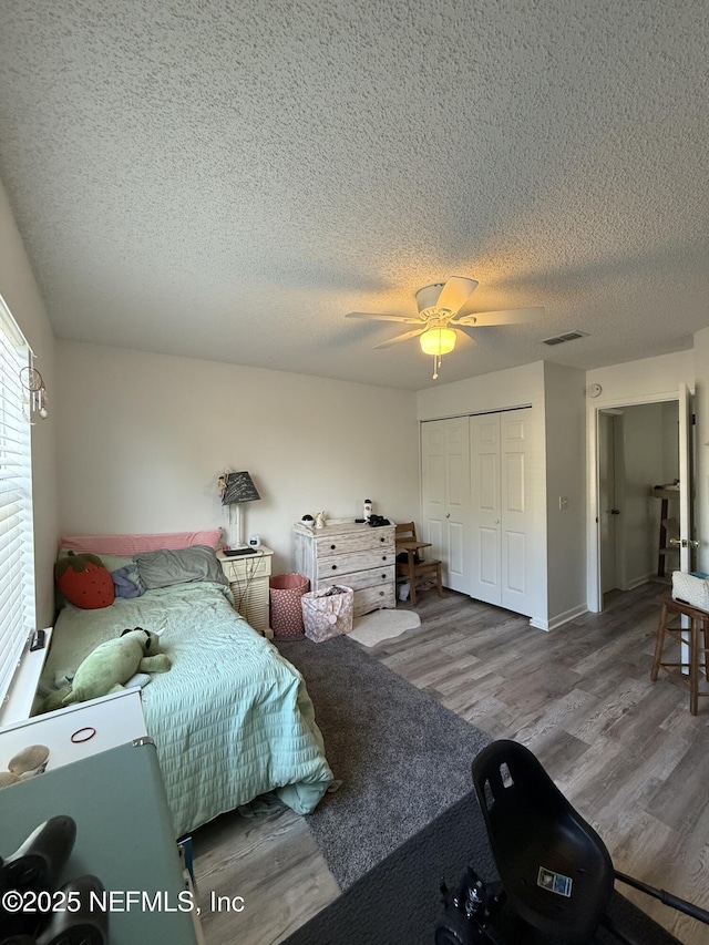 200 Spindrift Ln, Neptune Beach, FL 32266 - bedroom with wood finished floors, a textured ceiling, a closet, and ceiling fan