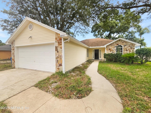 12011 Cobblestone Forest Cir S, Jacksonville, FL 32225 - view of front of property featuring stone siding, a garage, driveway, and a front lawn