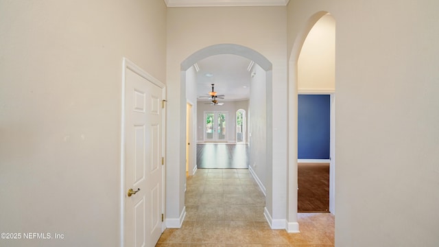1804 Ferncreek Dr, Saint Augustine, FL 32092 - hall featuring light tile patterned floors, baseboards, arched walkways, and ornamental molding