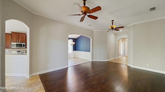 1804 Ferncreek Dr, Saint Augustine, FL 32092 - spare room with ceiling fan, arched walkways, ornamental molding, light wood finished floors, and baseboards