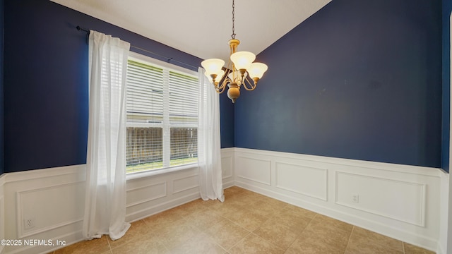 1804 Ferncreek Dr, Saint Augustine, FL 32092 - unfurnished room with a chandelier, plenty of natural light, lofted ceiling, a wainscoted wall, and a decorative wall