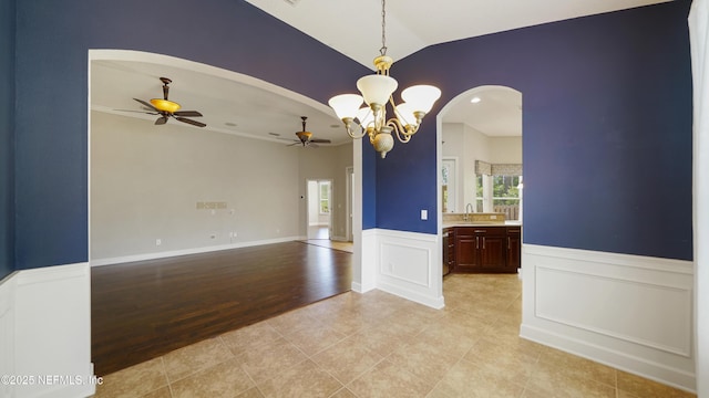 1804 Ferncreek Dr, Saint Augustine, FL 32092 - empty room featuring a ceiling fan, plenty of natural light, arched walkways, a sink, and wainscoting