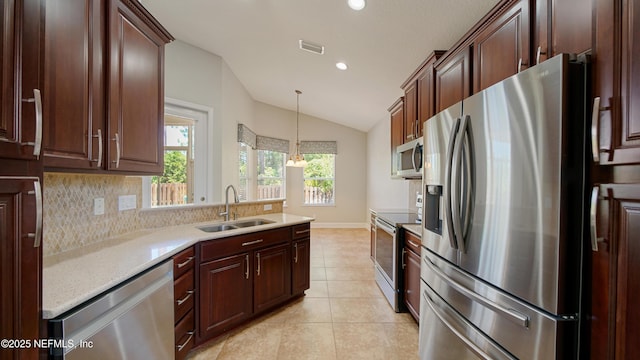 1804 Ferncreek Dr, Saint Augustine, FL 32092 - kitchen featuring appliances with stainless steel finishes, vaulted ceiling, a sink, light tile patterned floors, and recessed lighting