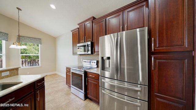 1804 Ferncreek Dr, Saint Augustine, FL 32092 - kitchen featuring appliances with stainless steel finishes, lofted ceiling, decorative backsplash, decorative light fixtures, and light tile patterned floors