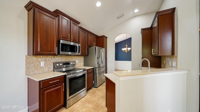 1804 Ferncreek Dr, Saint Augustine, FL 32092 - kitchen with appliances with stainless steel finishes, decorative backsplash, recessed lighting, light countertops, and vaulted ceiling