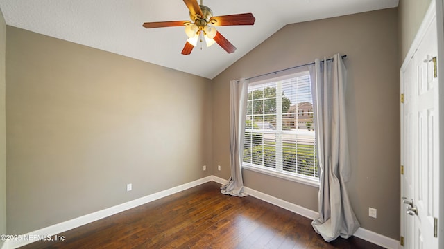 1804 Ferncreek Dr, Saint Augustine, FL 32092 - spare room featuring vaulted ceiling, baseboards, dark wood-type flooring, and ceiling fan