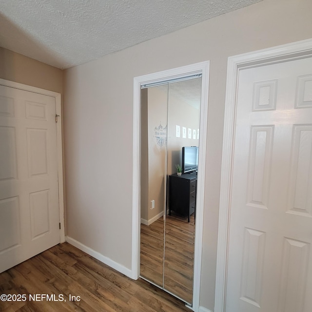 5201 Atlantic Blvd Unit 68, Jacksonville, FL 32207 - unfurnished bedroom with wood finished floors, a textured ceiling, and baseboards