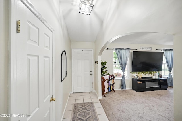 1537 Elmar Rd, Jacksonville, FL 32226 - carpeted foyer featuring arched walkways, tile patterned flooring, and baseboards