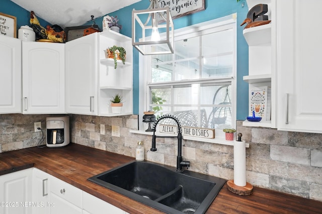 1537 Elmar Rd, Jacksonville, FL 32226 - kitchen with open shelves, wooden counters, a sink, and white cabinetry