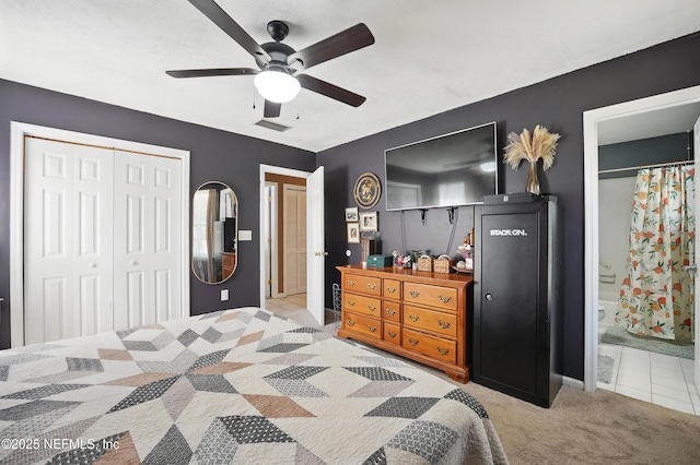 1537 Elmar Rd, Jacksonville, FL 32226 - carpeted bedroom with a closet, baseboards, tile patterned flooring, ceiling fan, and ensuite bathroom