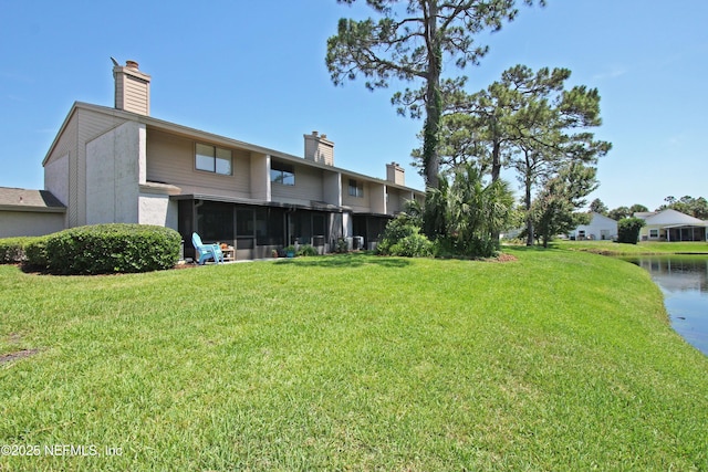 2105 Sandpiper Ct, Ponte Vedra Beach, FL 32082 - back of house with a chimney, a sunroom, a yard, and a water view