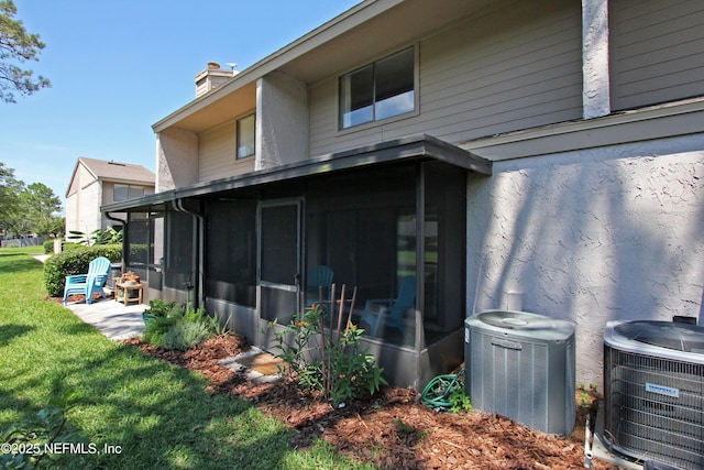 2105 Sandpiper Ct, Ponte Vedra Beach, FL 32082 - rear view of house with a sunroom, central AC, a chimney, and a yard